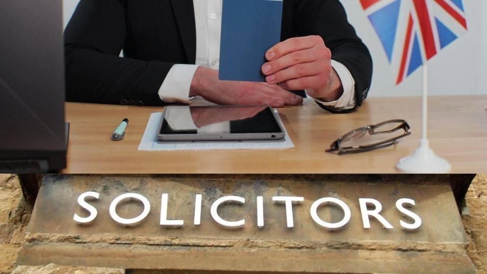 (In the image a business immigration solicitor can be seen approving a visa)