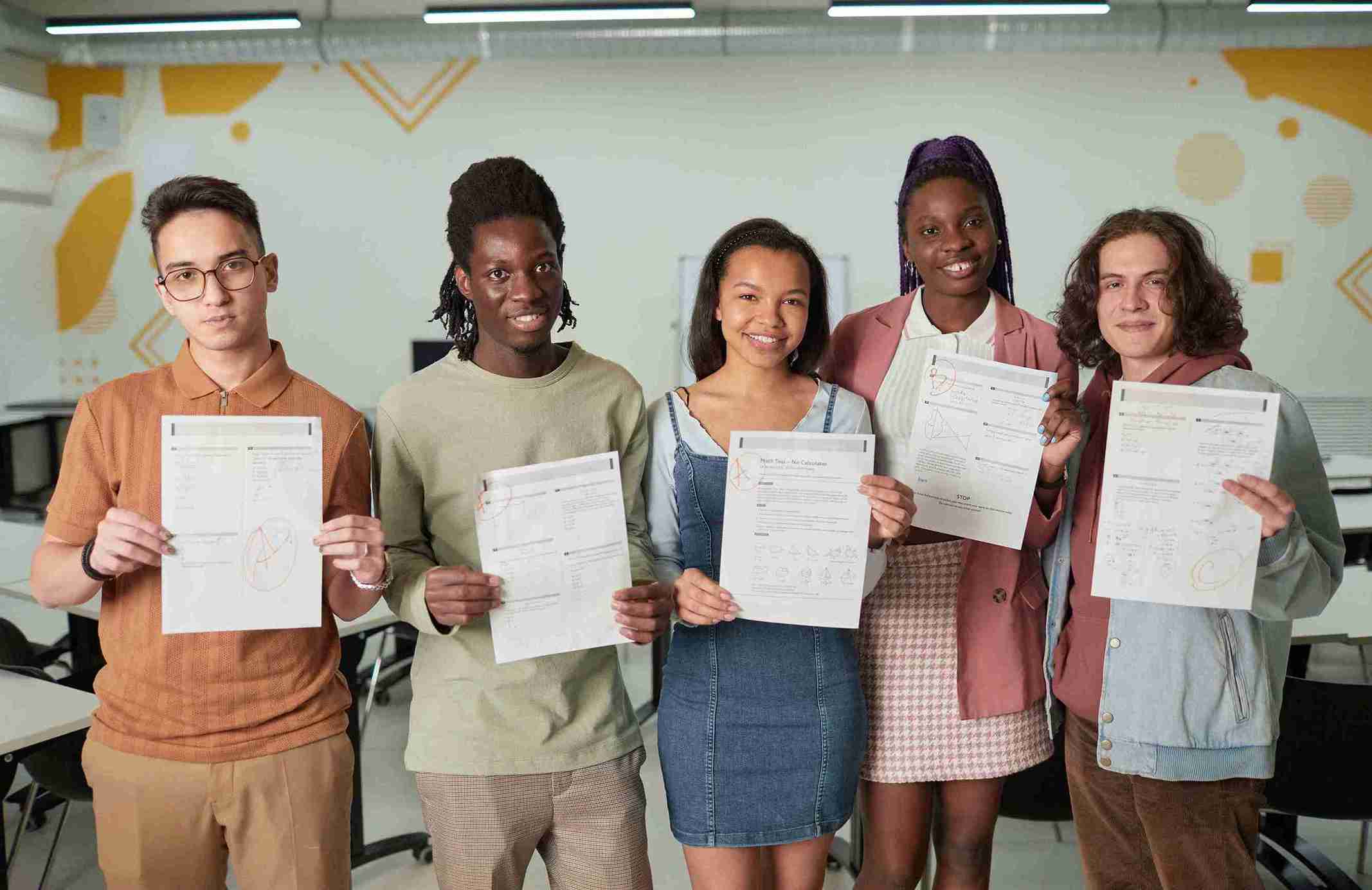 Young people in a office holding papers, showing the certificates about the Start-Up in UK .