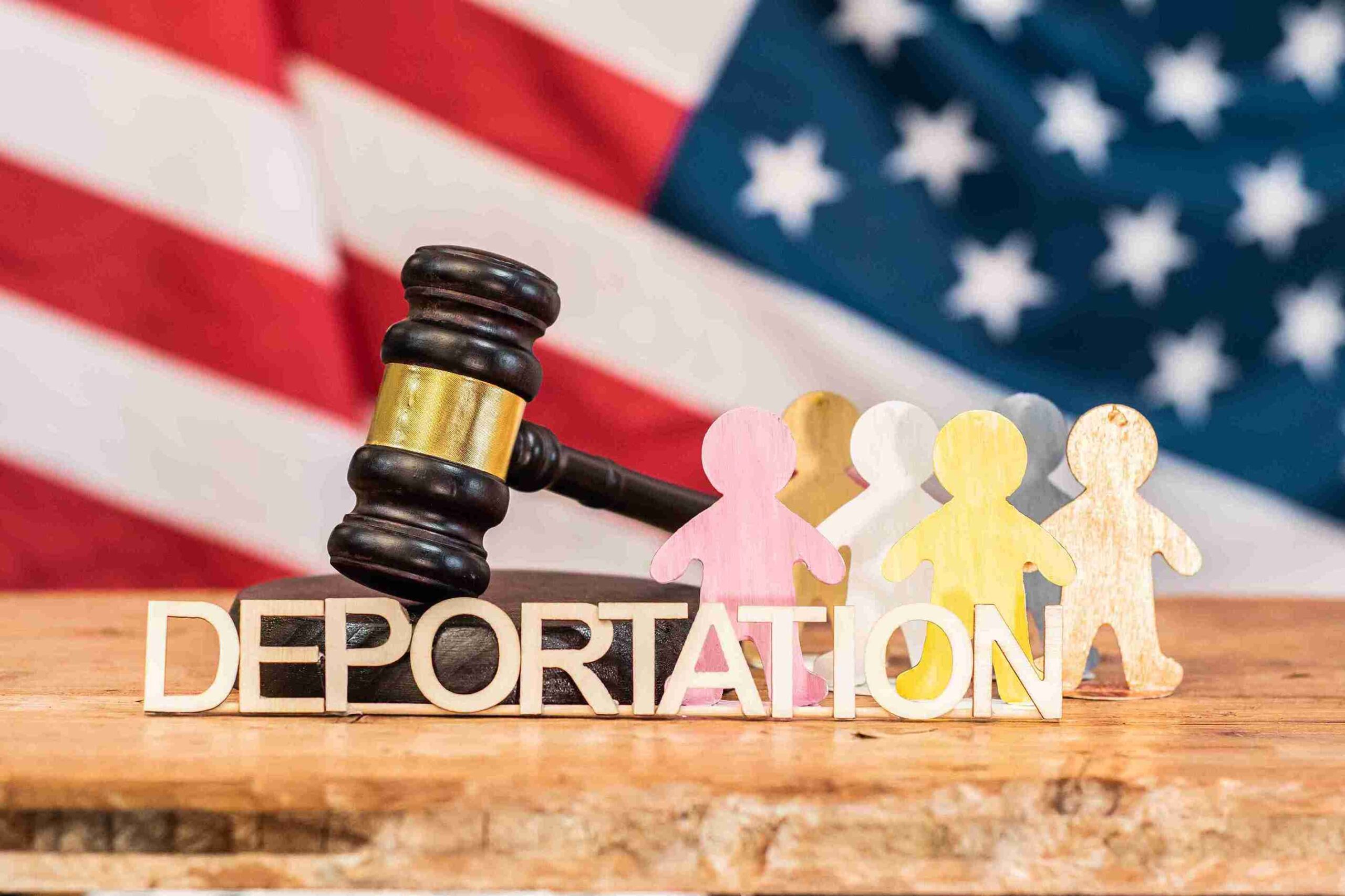 Image depicting the deportation of illegal immigrants, showing officials escorting individuals onto a transport vehicle.