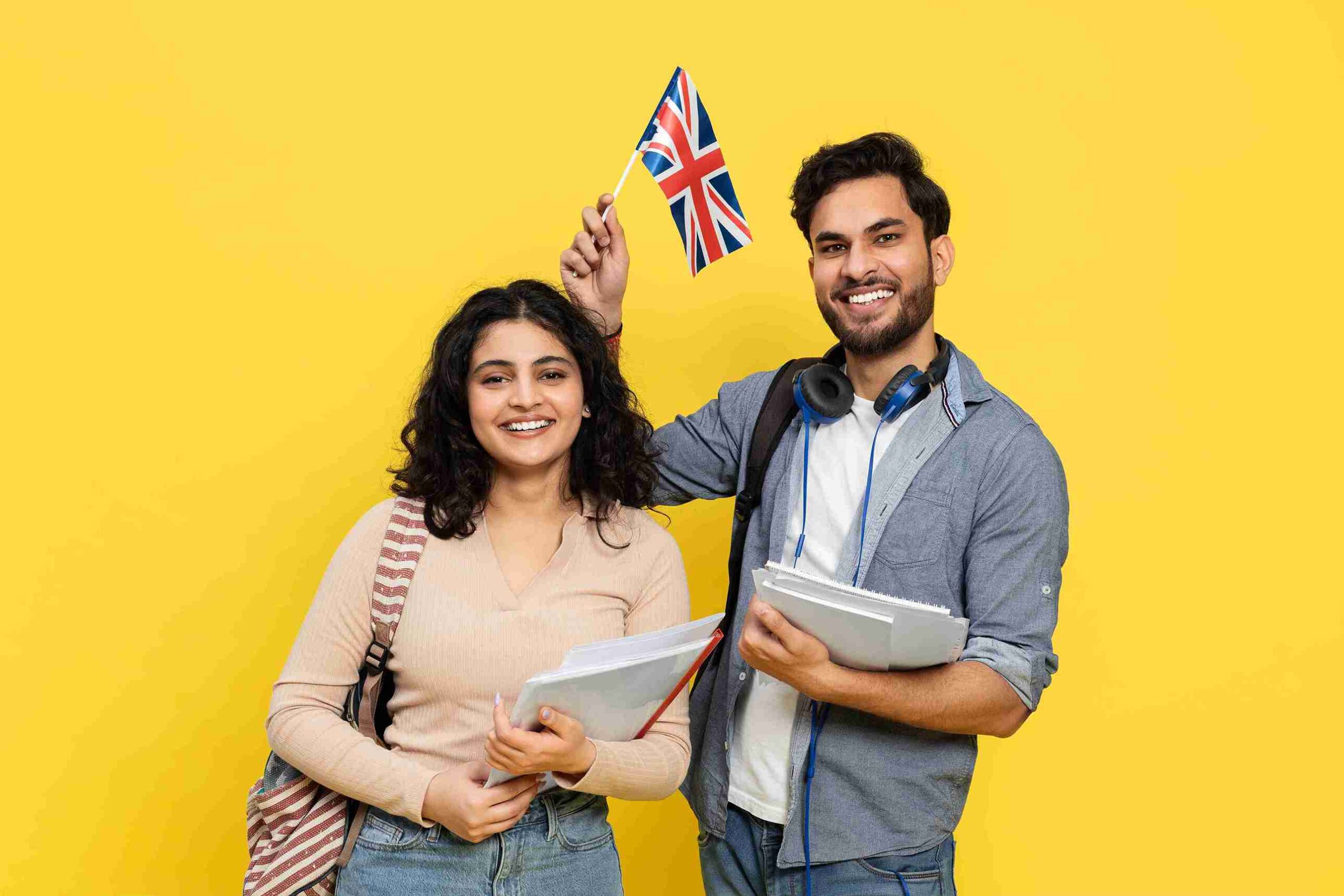Couple smiling and holding a British flag, celebrating their connection to the UK.