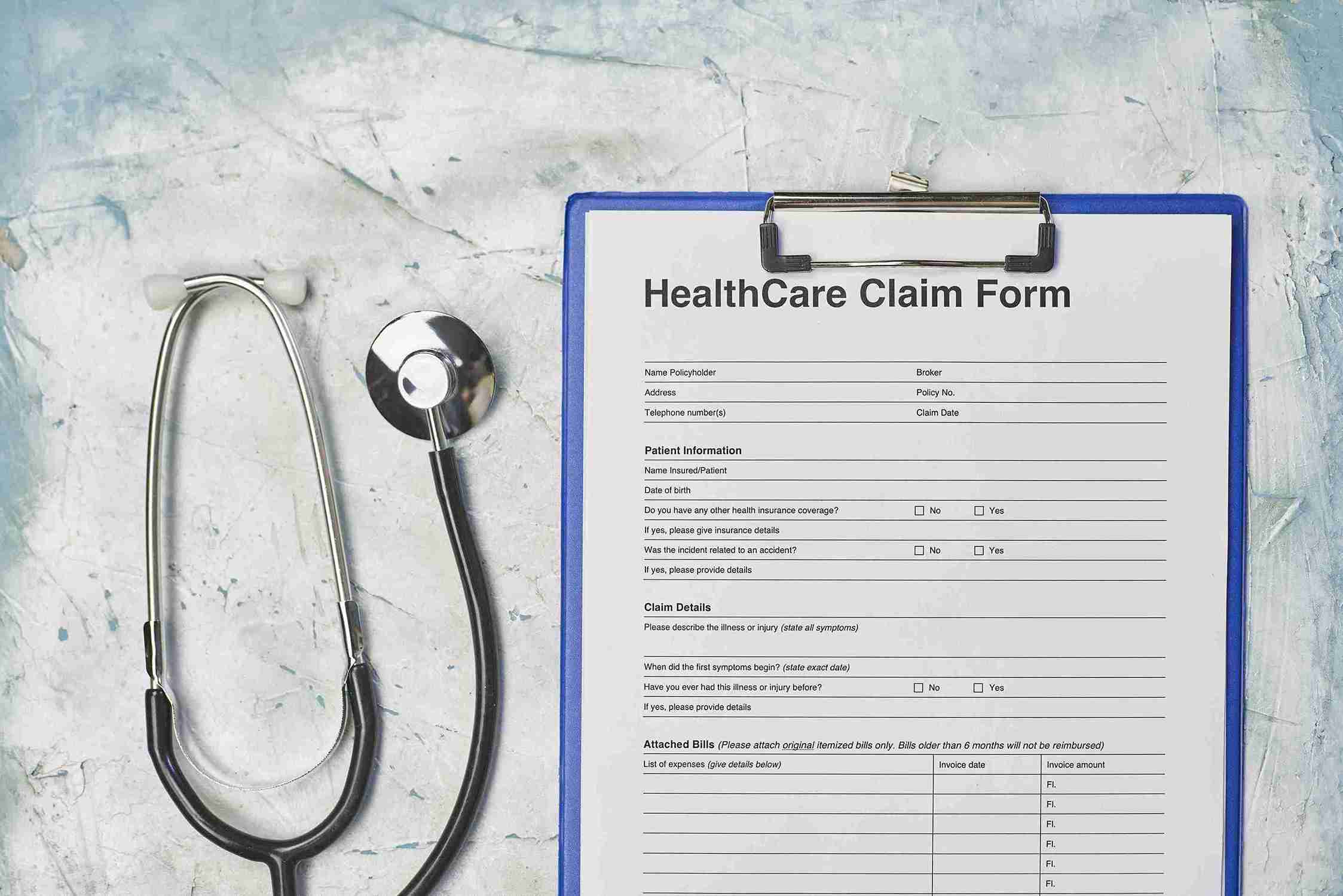 Health care claim form attached to a clipboard, relevant for Health & Care Worker Visa applications.