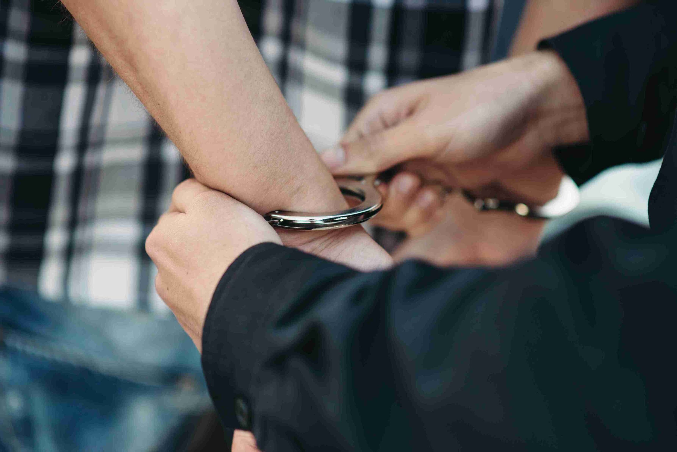A man holds a wrist cuff in his hand, showcasing its design and material.