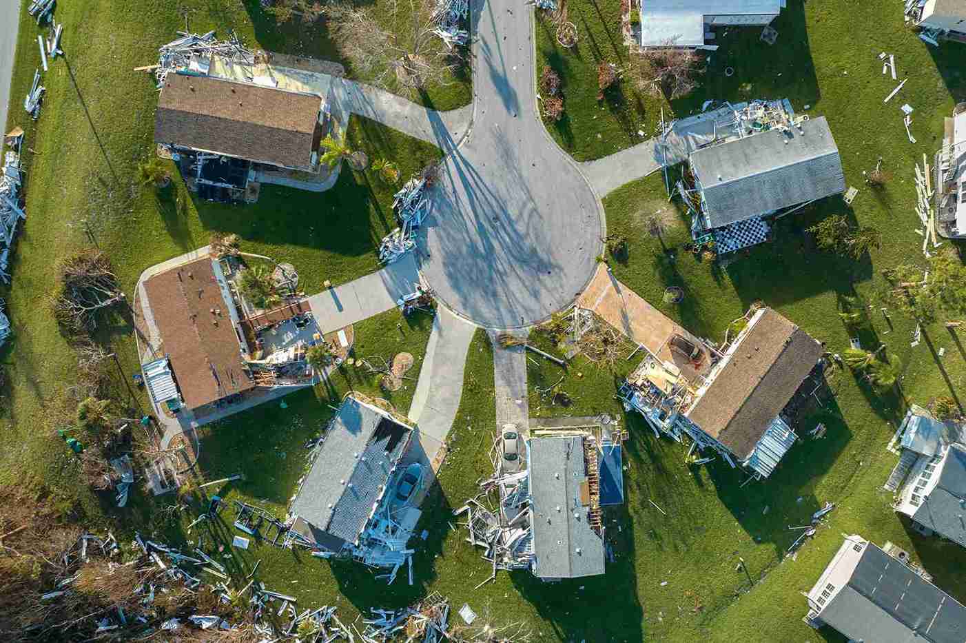 Aerial view of a neighborhood showcasing houses and trees, highlighting property encroachments in the landscape.