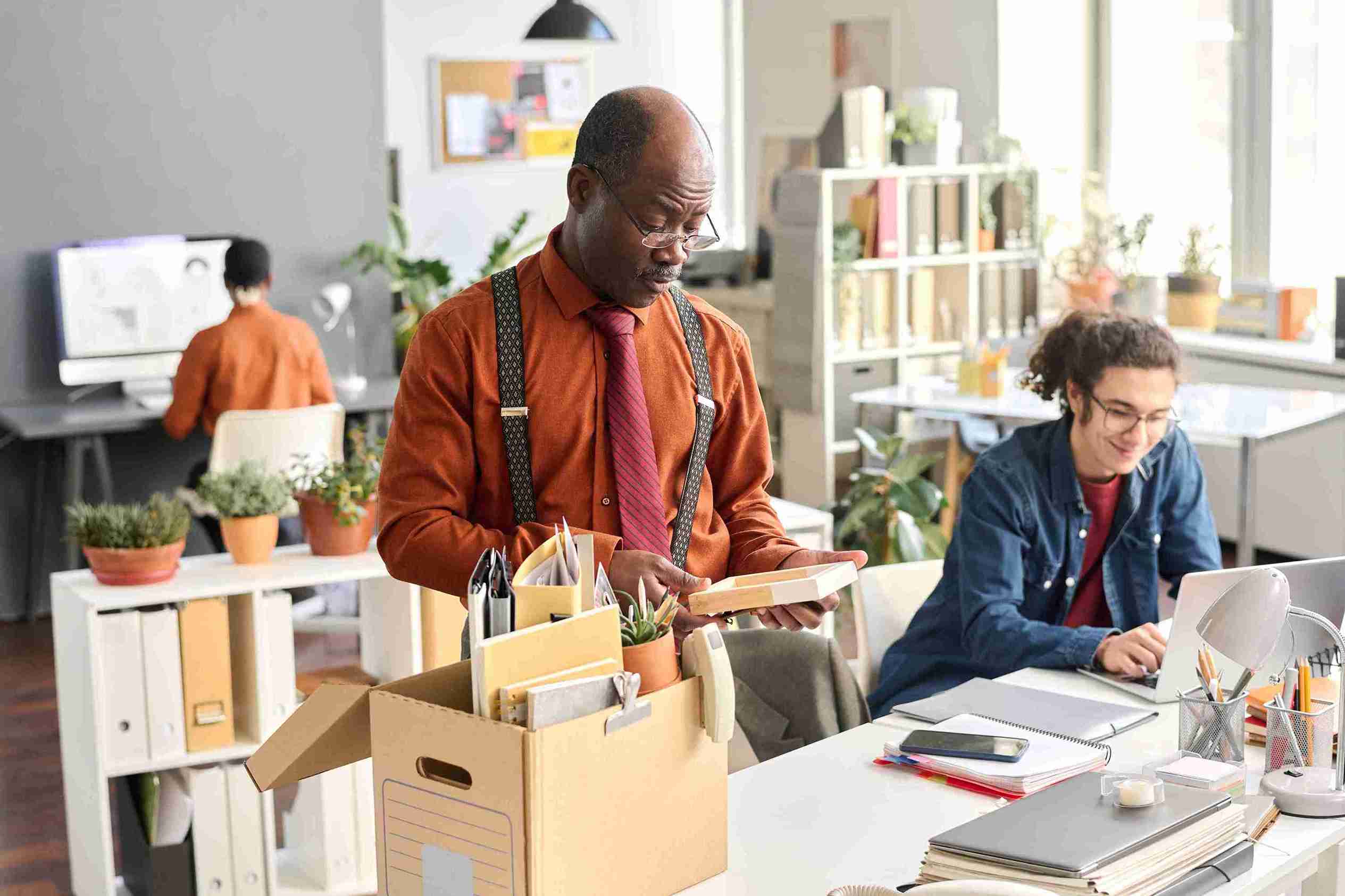 A man and woman collaborate on a project in a modern office setting, focused and engaged in their work.