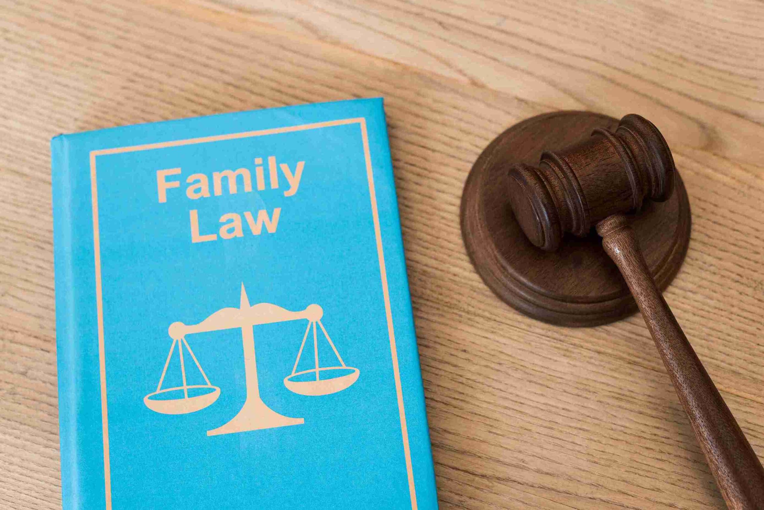 Family law book with the word "Injunctions" visible, alongside a wooden gavel on a table.