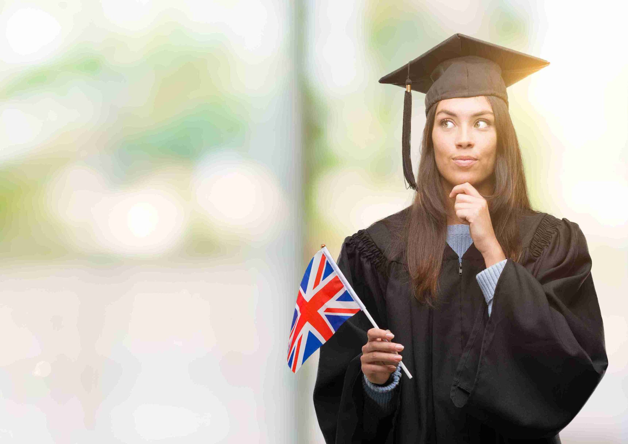 A graduate student proudly holding a British flag, symbolizing their academic achievement in the UK